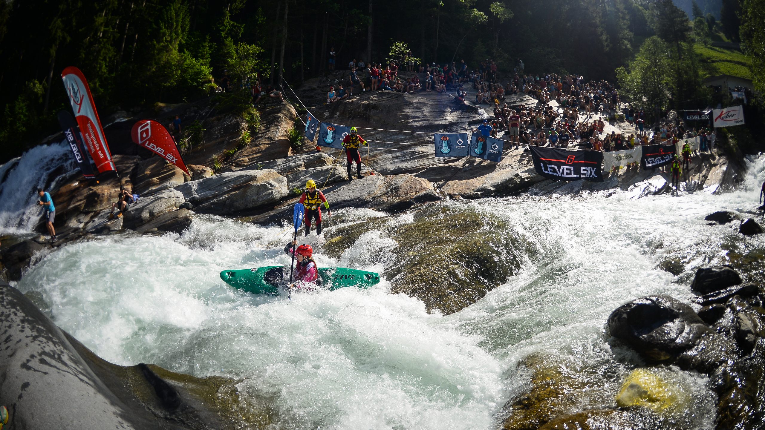 annakayaks King of the Alps extreme kayak championships. Whitewater kayaker girl in a steep rapid.