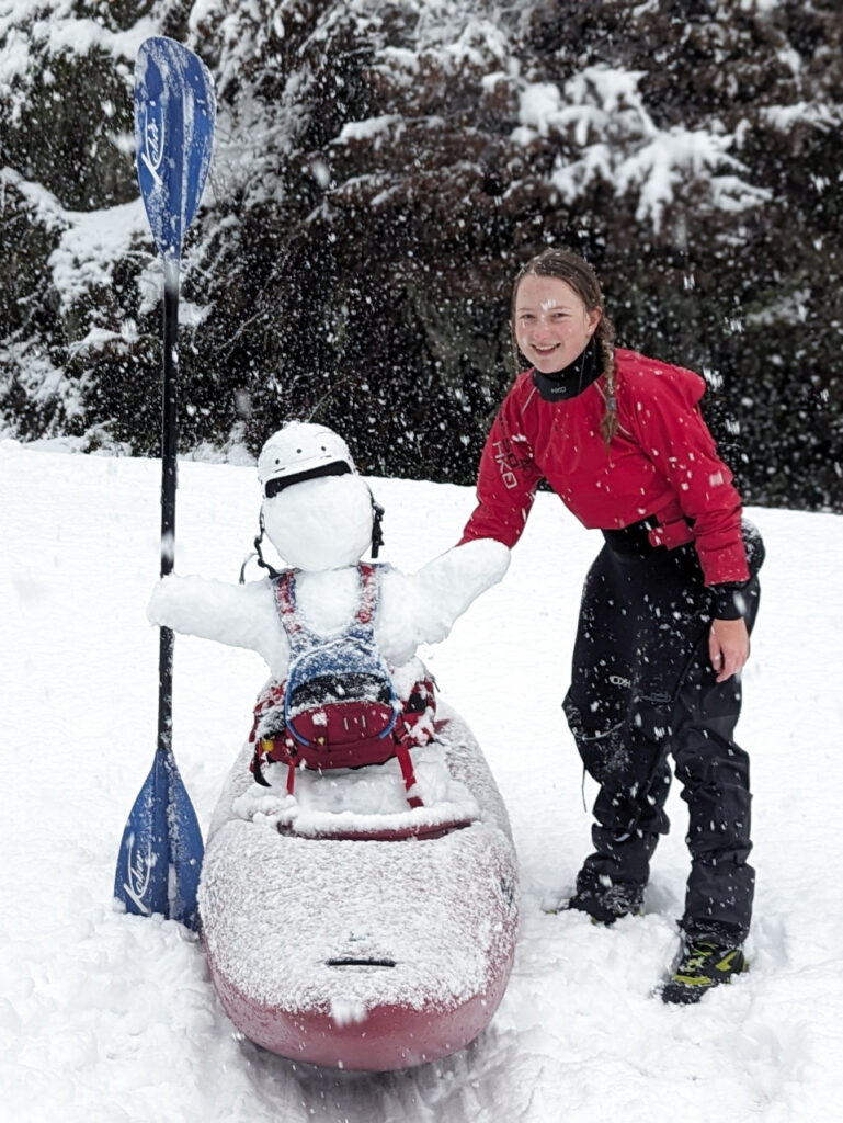 Snowman in whitewater kayak and gear.