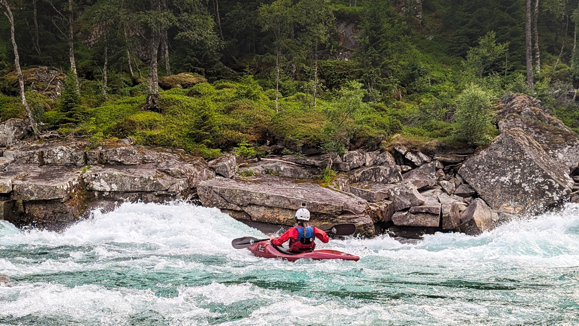 Paddling Raundalselva river in Norway.